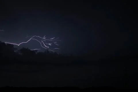 A dark sky with a lightning bolt in the middle Stock Photos