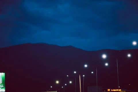 A dark sky with a mountain range in the background Stock Photos