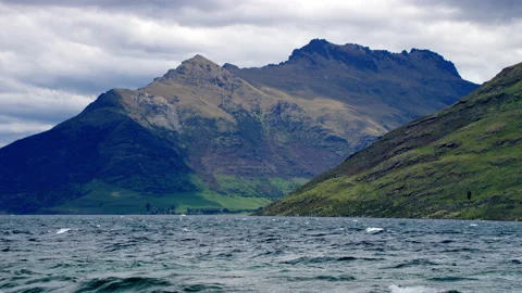Dark sky with rough lake and large mountains in NZ Stock Footage 159748666