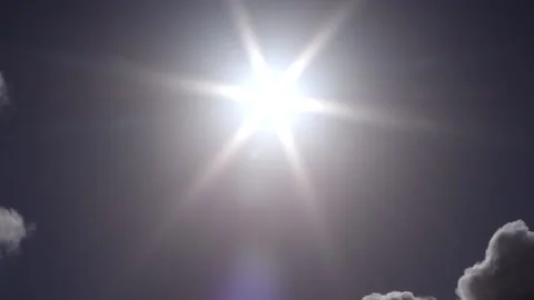 Dark sky with small clouds, sun, sunbeams - sky background - Time Lapse Stock Footage 153952117