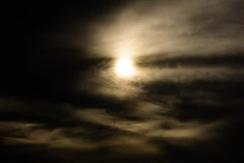 A dark sky with a sun in the middle Stock Photos