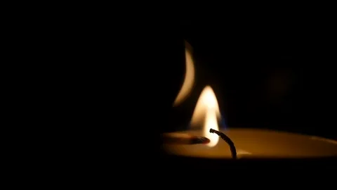 Dark slow motion of man lighting candle with a match Burning in the Temple. Stock Footage 146454592