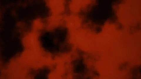 Dark smoke clouds create a vivid red and black background Stock Footage 340277167