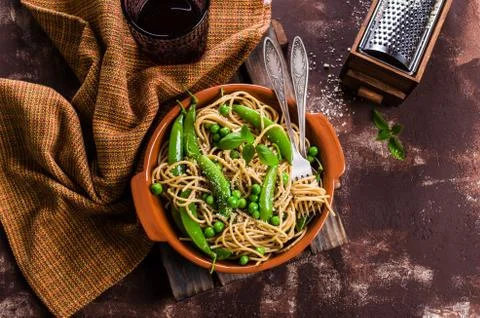 Dark spaghetti with peas Stock Photos