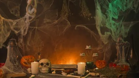 Dark spooky kitchen in spider webs, with sinister pumpkins the table Stock Photos