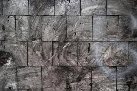 Dark spots on the tile wall after fire. Abstract grunge background. High quality Stock Photos