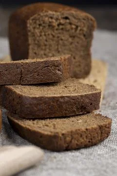 Dark square loaf of bread on the table Foto stock