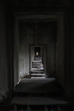 Dark Stone Corridor Inside Ancient Angkor Wat Temple in Cambodia Stockfoto's