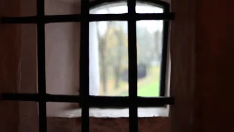 Dark stone prison inside a medieval castle, rusty bars, chains, 4K ultra HD. Stock Footage 321150273