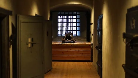 Dark stone prison inside a medieval castle, rusty bars, chains, 4K ultra HD. Stock Footage 321152684