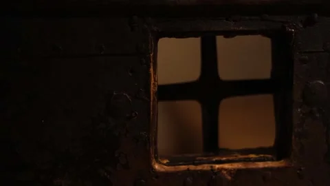 Dark stone prison inside a medieval castle, rusty bars, chains, 4K ultra HD. Stock Footage 321153057