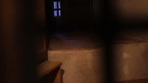 Dark stone prison inside a medieval castle, rusty bars, chains, 4K ultra HD. Stock-Footage 321153065