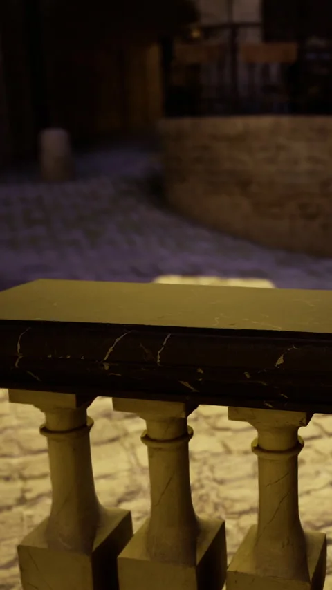 Dark stone surface sits on columns in an outdoor setting at night 動画素材 334110253