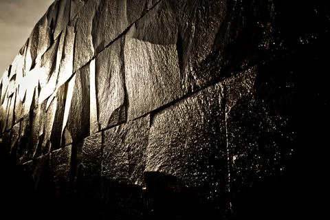 Dark stone wall shining with the light Stock Photos