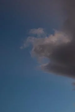 Dark Storm Cloud Against Blue Sky Foto stock