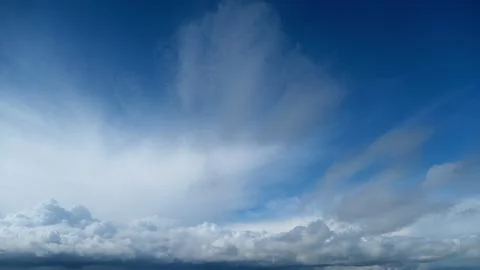 Dark storm cloud gathering in blue sky, time lapse. Ominous weather condition Stock Photos