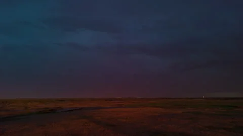 Dark storm clouds and heavy rain over landscape captured from drone before Stock Footage 335960190