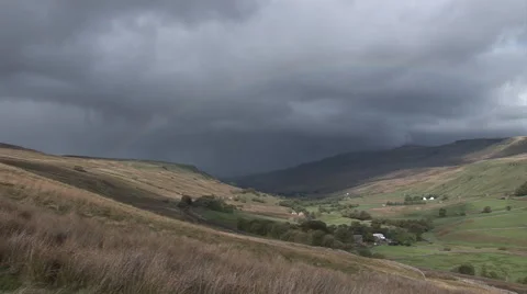 Dark storm clouds and a rainbow over the Cumbrian fells near Aisgill Video stock 42632469
