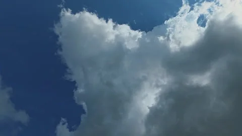 Dark storm clouds clearing revealing blue sky Stock Footage 335369265