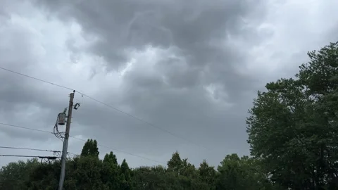 Dark storm clouds form over power lines Stock Footage 329575039