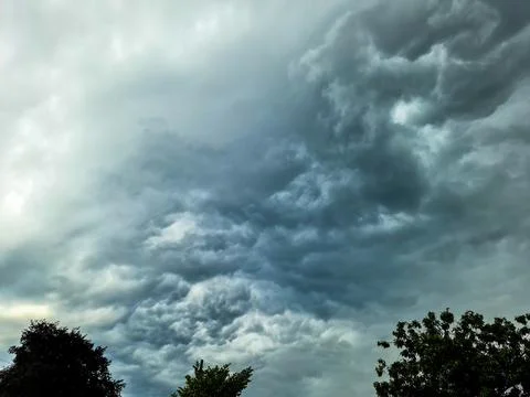 Dark storm clouds form in the sky ahead of a thunderstorm. Stock Photos