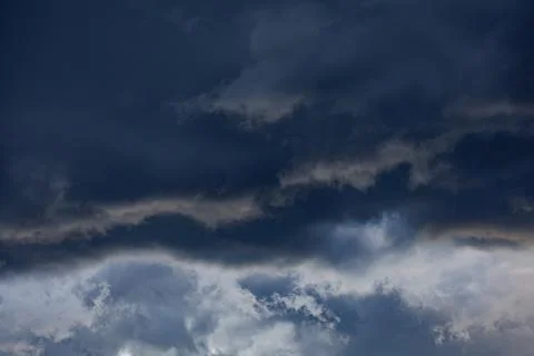 Dark storm clouds forming before heavy rain in dramatic sky, bad weather and nat Stock Photos