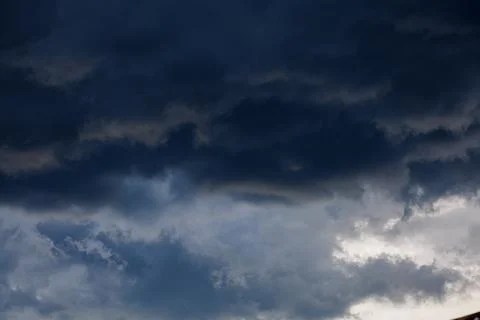 Dark storm clouds forming before heavy rain in dramatic sky, bad weather and nat Stock Photos