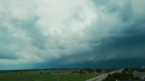 Dark storm clouds forming over the countryside before severe weather. Dramatic Stock Footage 340448447