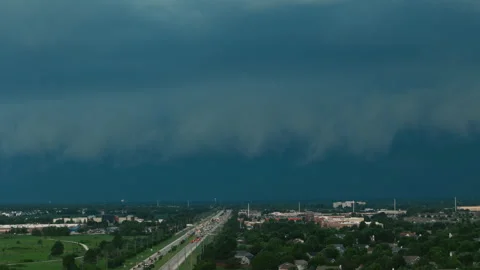 Dark storm clouds forming over the countryside before severe weather. Dramatic Stock Footage 340449546