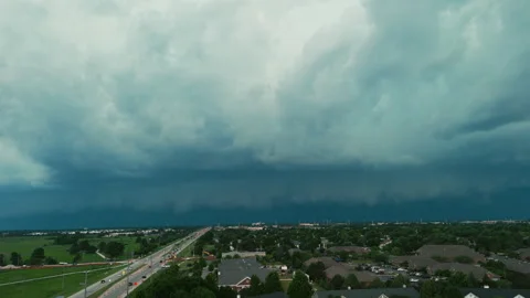 Dark storm clouds forming over the countryside before severe weather. Dramatic Vidéo 345477918