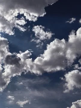 Dark Storm Clouds Framing Deep Blue Open Sky Stock Photos
