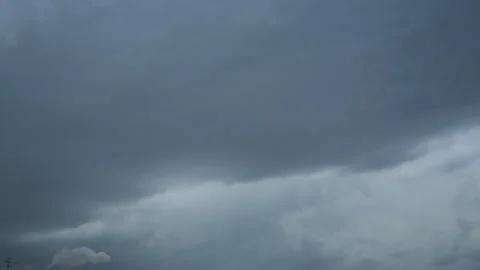 Dark storm clouds gather ominously in the sky, creating an awe-inspiring backdro Stock Footage 338001199