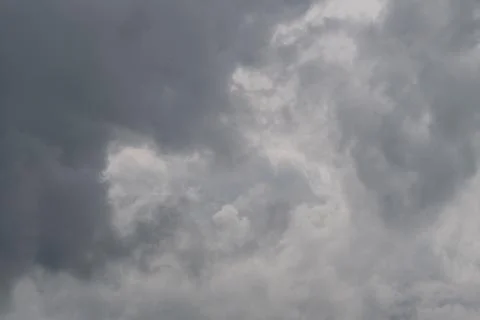 Dark storm clouds gather overhead, heavy nimbus layers signaling incoming r.. Stock Photos