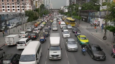 Dark storm clouds gathering above busy commuter traffic, downtown Bangkok Stock Footage 70798514