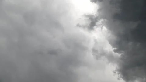 Dark storm clouds gathering and rolling across overcast sky in timelapse Stock Footage 335317685