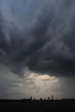 Dark Storm Clouds Gathering Over Rural Landscape Stock Photos