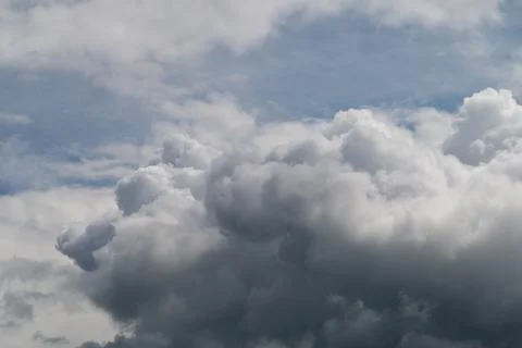 Dark storm clouds gathering over horizon, heavy cumulonimbus layers, deep gra Stock Photos