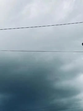 Dark Storm Clouds Gathering in Sky with Overhead Power Lines Stock Photos