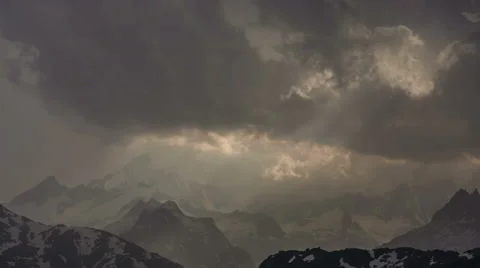 Dark storm clouds gathering sunbeams moving over Finsteraarhorn peak  Stock Footage 53105643