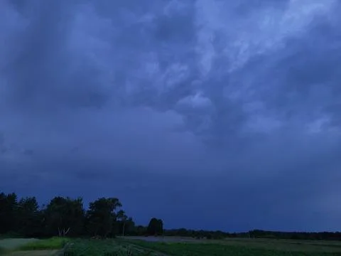 Dark storm clouds before heavy summer rain or thunderstorm Stock Photos