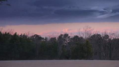 Dark storm clouds on the horizon against treeline Stock Footage 209548895