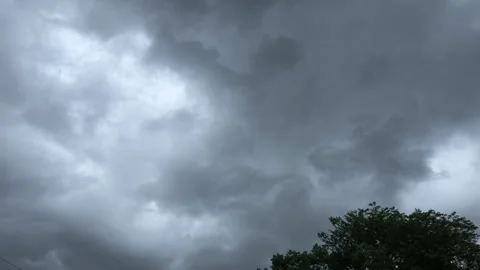 Dark storm clouds move across the sky on a windy day Stock Footage 329575043