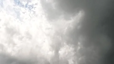 Dark storm clouds moving across bright sky Stock Footage 315703583