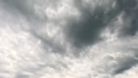Dark storm clouds moving across gray sky Stock Footage 318947499