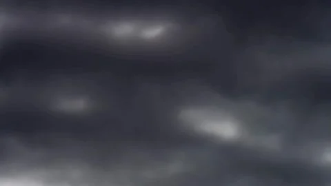 Dark storm clouds moving across a deep blue sky Stock Footage 329751330