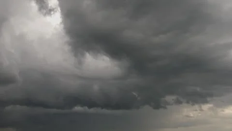 Dark storm clouds moving in semicircle formation across gloomy rainy sky. Video stock 332485080
