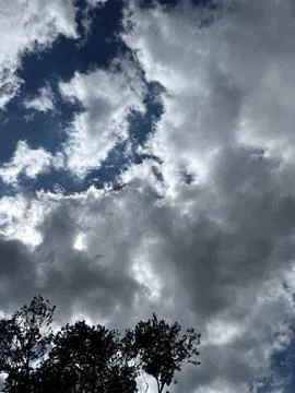Dark Storm Clouds Opening to Blue Sky Stock Photos