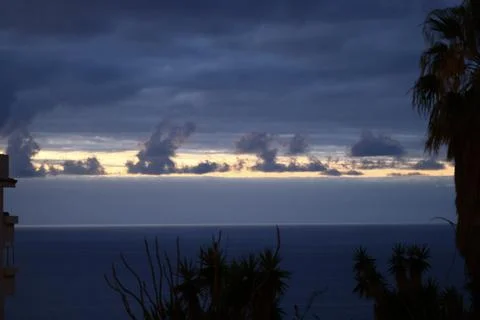 Dark storm clouds over Atlantic Ocean before sunrise with dramatic seascape 스톡 사진