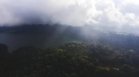 Dark storm clouds over green forest with heavy rain Fotos Stock