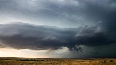 Dark storm clouds over open land Fotos Stock